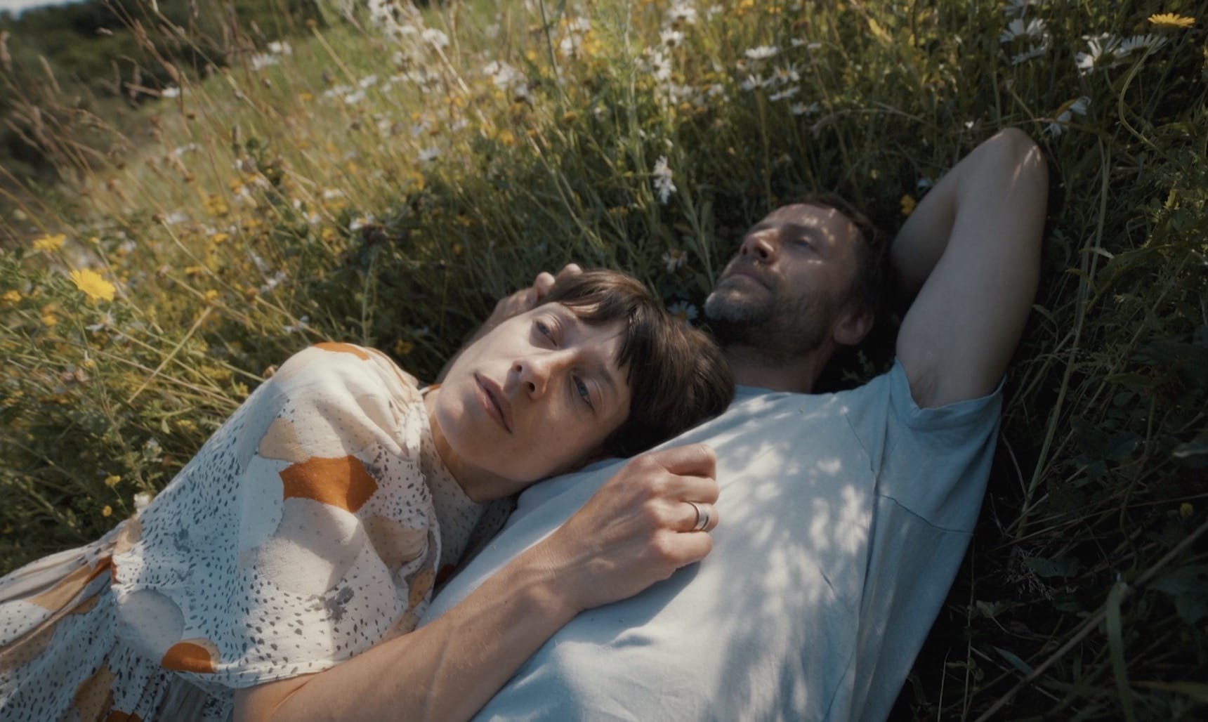 A couple lying in the grass